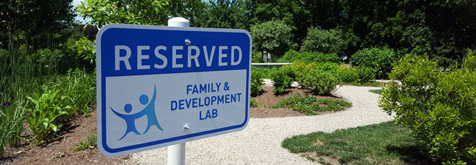 A sign that says Reserved for Family & Development Lab